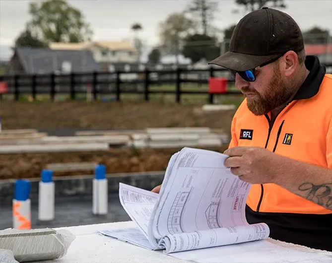RFL crew member reading the slab plans on site
